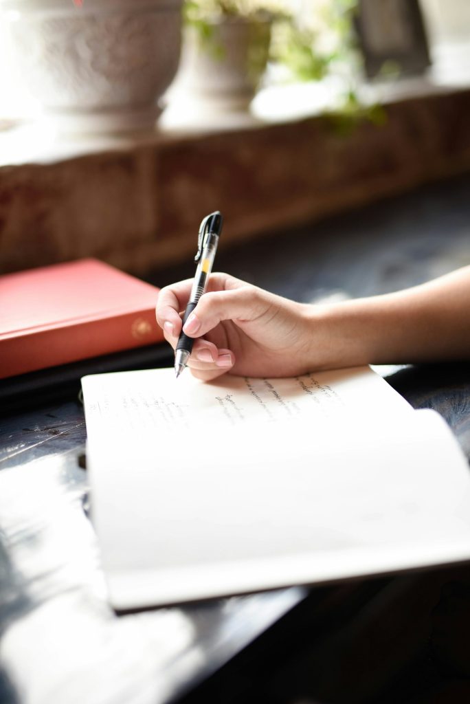 Handwriting in notebook with black pen